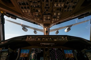 An airplane refuels another airplane.