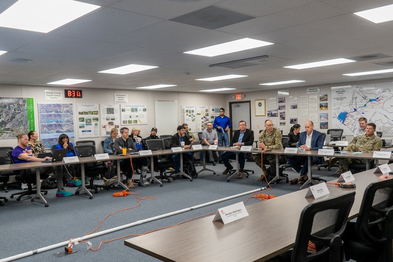 People sit a table during a meeting.