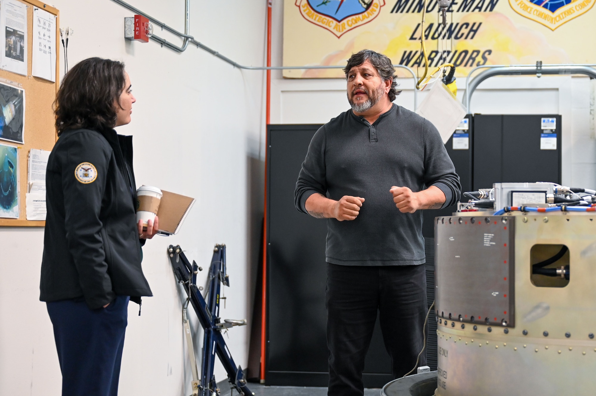 Medrano talks to Dalton inside a workshop.