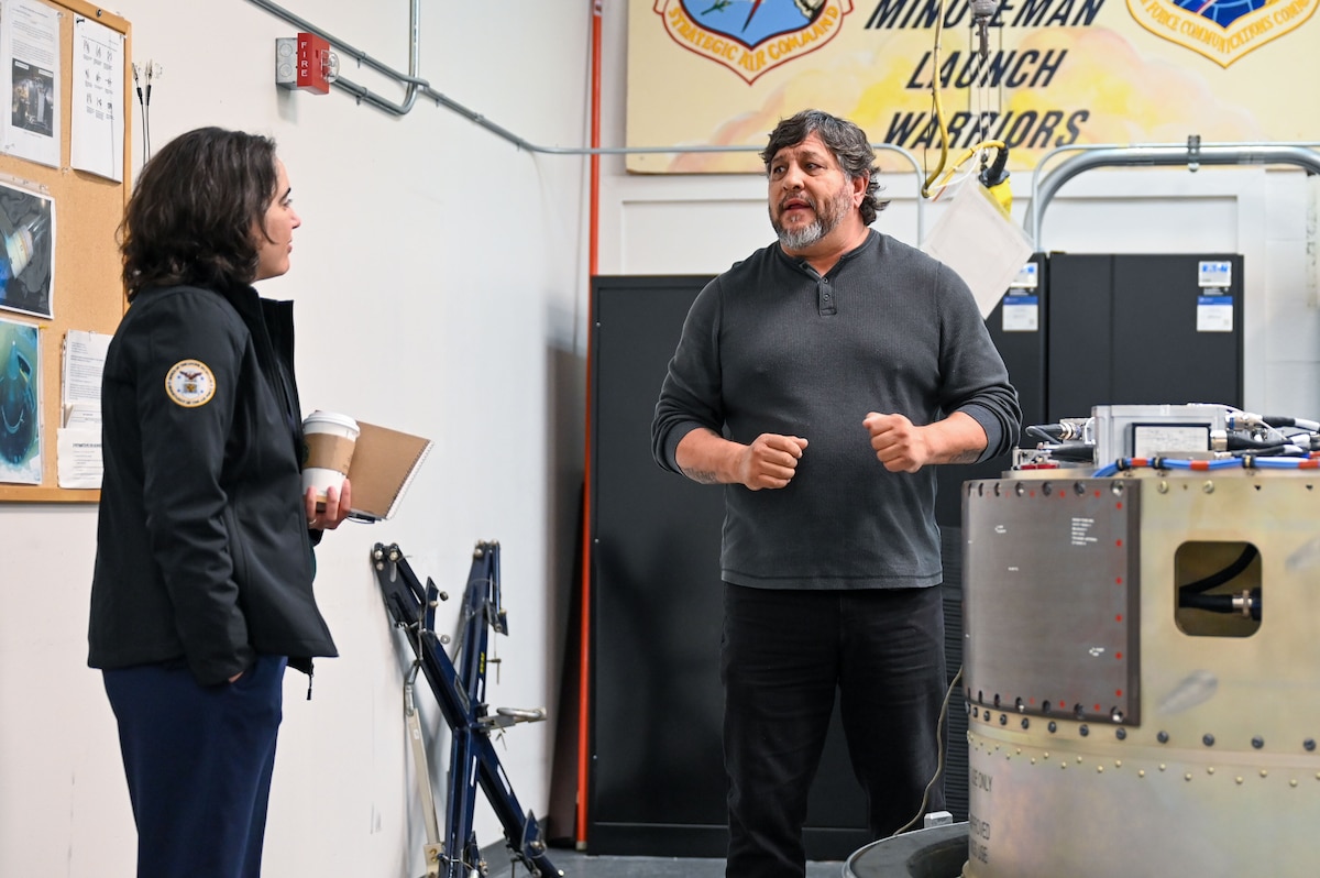 Medrano talks to Dalton inside a workshop.