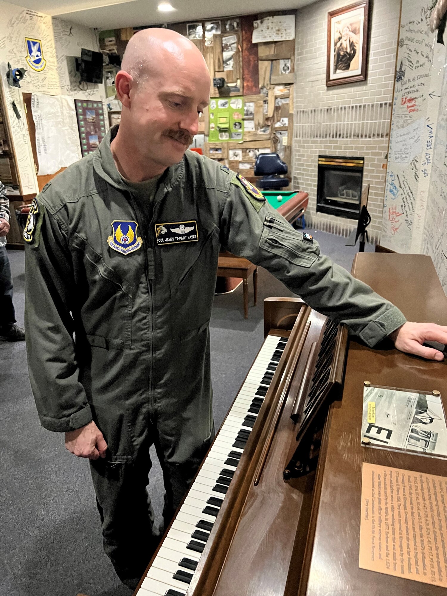 Col. James Hayes looks at the final product on his grandmother’s piano.