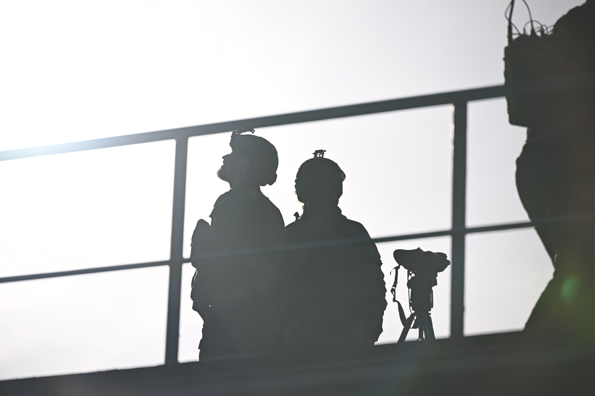 A photo of two peoples' silhouetted figures.