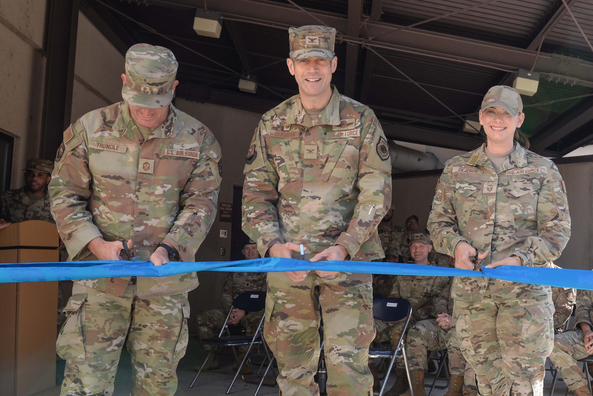 From left, U.S. Air Force Chief Master Sgt. Joshua S. Trundle, 51st Fighter Wing command chief, Col. William McKibban, 51st FW commander, and Senior Master Sgt. Emily Dejesus, 51st Civil Engineer Squadron first sergeant, cut a ribbon at the new Airman’s Attic at Osan Air Base, Republic of Korea, Oct. 23, 2024. The ribbon cutting ceremony signifies the grand opening of the new Airman’s Attic location. (U.S. Air Force photo by Staff Sgt. Kahdija Slaughter)