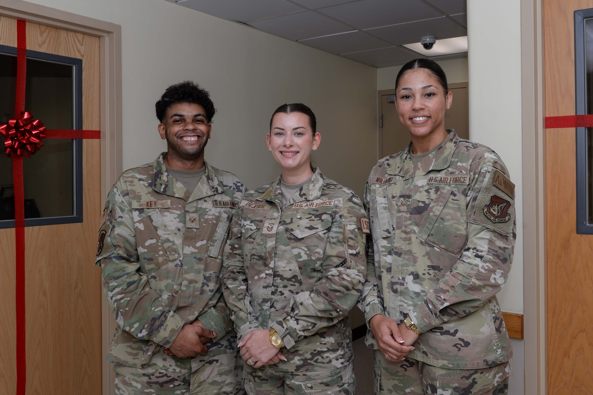 U.S. Air Force Staff Sgt. Joshua Key, left, 51st Security Forces Squadron administration assistant, Master Sgt. Emily Dejesus, middle, 51st Civil Engineer Squadron first sergeant, and Staff Sgt. Rochelle Williams, 51st Security Forces Squadron administration assistant, pose for a photo in front of the Airman’s Attic at Osan Air Base, Republic of Korea, Oct. 23, 2024. The Osan Airman’s Attic held a ribbon cutting ceremony for the grand opening of the new location on the fourth floor of building 386. (U.S. Air Force photo by Staff Sgt. Kahdija Slaughter)
