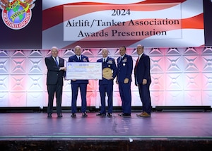 92nd Air Refueling Wing accepts award with Secretary of the Air Force, Frank Kendall, AMC Commander, General John LaMontagne, and Deputy Assistant Secretary of the Air Force for Operational Energy, Safety, and Occupational Health, Roberto Guerrero