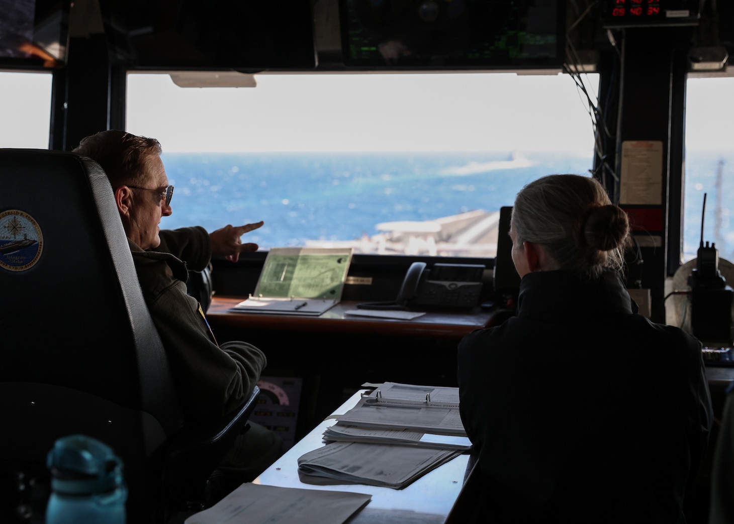 Capt. Richard Burgess, commanding officer of USS Gerald R. Ford (CVN 78), left, and Capt. Fiona Halbritter, right, a senior assessor from Carrier Strike Group 4 observe USS Forrest Sherman (DDG 98), USS Mahan (DDG 72), and USS Winston Churchill (DDG 81) during a strait transit as part of Carrier Strike Group 12, Gerald R. Ford Carrier Strike Group in the Atlantic Ocean, Nov. 12, 2024.