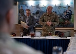 U.S. Air Force Brig. Gen. Patrick Miller, Air Force Civil Engineer Center commander, Joint Base San Antonio-Lackland, Texas, talks with service members at Royal Air Force Mildenhall, England, Nov. 14, 2024. Miller attended meetings about RAF Mildenhall’s current infrastructure needs and requirements. (U.S. Air Force photo by Senior Airman Nash Truitt)