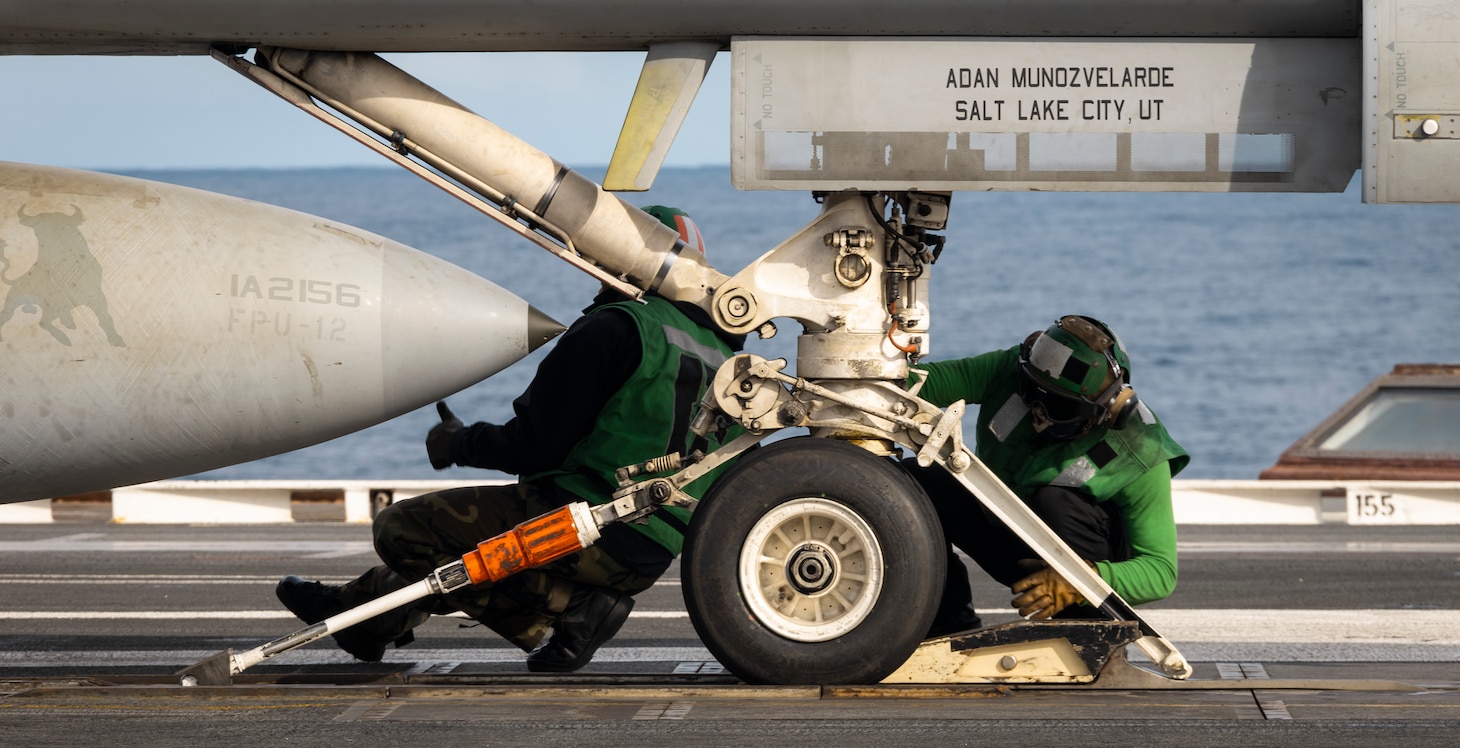 Aviation Boatswain's Mate (Equipment) 1st Class Spencer Taylor (left), and Aviation Boatswain's Mate (Equipment) 2nd Class Pascual Covarrubias, both assigned to air department aboard the world's largest aircraft carrier, USS Gerald R. Ford (CVN 78), perform catapult checks on the flight deck during flight operations, Nov. 14, 2024