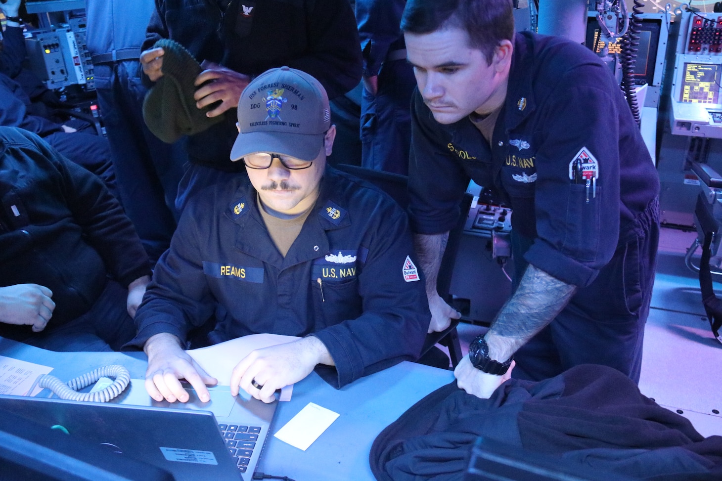 Chief Information System Technicians (IT)C Christopher Reams and Zachary Schools, assigned to Combat Systems  department onboard the Arleigh Burke-class guided-missile destroyer USS Forrest Sherman (DDG98), sets up the Battlefield Information Collection and Exploitation System (BICES) in preparation for Group Sail events inside combat information center, November 10, 2024.