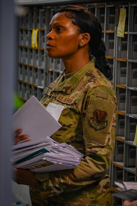 Pennsylvania Air National Guard Airman Master Sgt. Sheika Lupo, 111th Force Support Squadron, finds a mail package for a customer at Ramstein Air Base, Germany, Nov. 5th, 2024. 111th ATKW airmen trained with mail team members at Ramstein AB to practice interoperability and Multi-capable airmen functioning in a deployed environment. (Pennsylvania Air National Guard photo by Senior Airman Charles Casner)