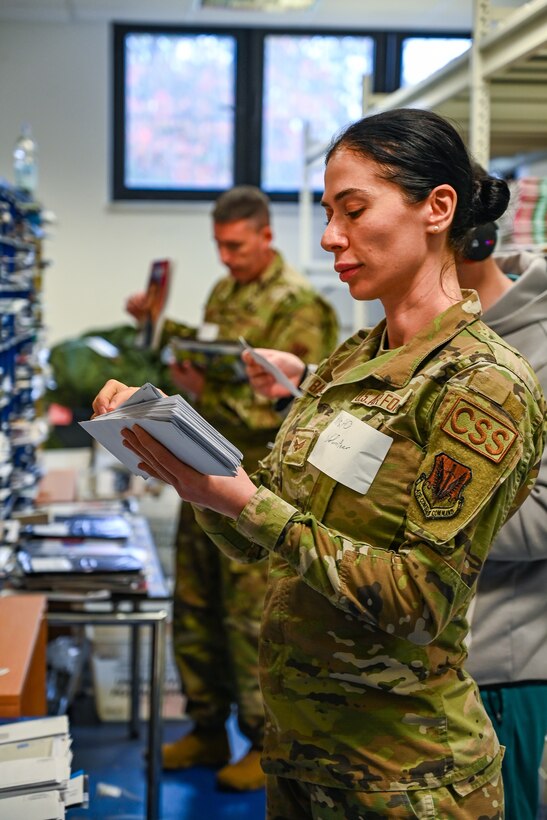 Pennsylvania Air National Guard Senior Airman Bella Badal, assigned to the 111th Operations Group and Staff Sgt. Michael Eagan, 111th Force Support Squadron, review and distribute mail in a mailroom on Ramstein Air Base Germany, Nov. 05, 2024. 111th ATKW airmen trained with mail team members at Ramstein AB to practice interoperability and Multi-capable airmen functioning in a deployed environment. (Pennsylvania Air National Guard photo by Senior Airman Charles Casner)