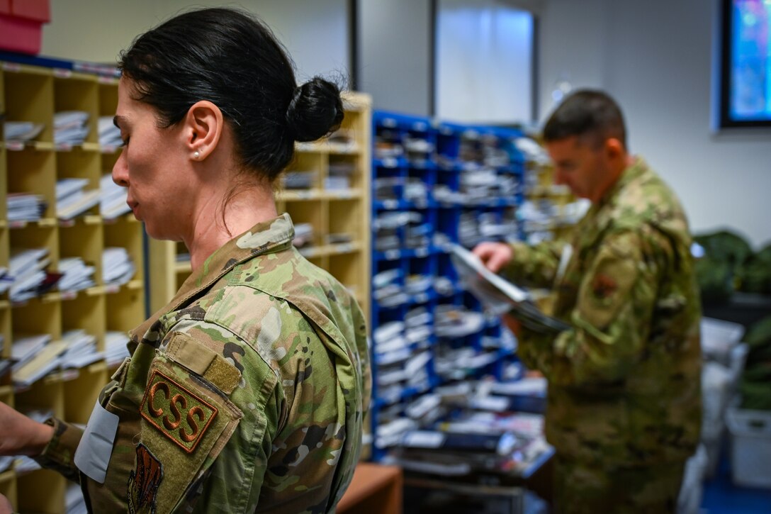 Pennsylvania Air National Guard Senior Airman Bella Badal, assigned to the 111th Operations Group and Staff Sgt. Michael Eagan, 111th Force Support Squadron, review and distribute mail in a mailroom on Ramstein Air Base Germany, Nov. 05, 2024. 111th ATKW airmen trained with mail team members at Ramstein AB to practice interoperability and Multi-capable airmen functioning in a deployed environment. (Pennsylvania Air National Guard photo by Senior Airman Charles Casner)
