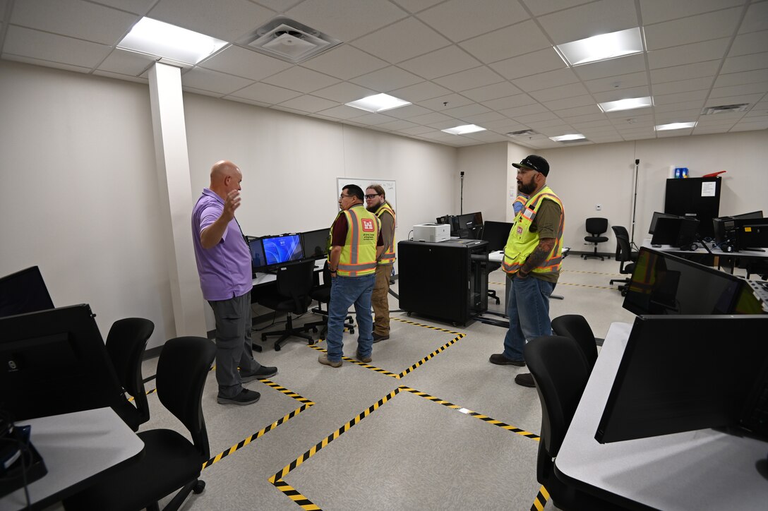 Thomas Harraghy, chief of the Missile Defense Agency’s Kingdom of Saudi Arabia Terminal High Altitude Area Defense Training Academy describes the workstation set up in the newly renovated building 1093 on Fort Bliss, Texas. Pictured from left to right are Harraghy, Alex Espinoza, a quality assurance representative from the U.S. Army Corps of Engineers, Fort Worth District’s Southwest Area Office, Andrew Davis, the project’s engineer from the Southwest Area Office, and David Patterson, a construction representative from the Southwest Area Office.