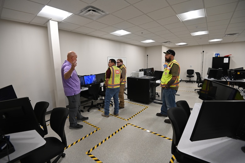 Thomas Harraghy, chief of the Missile Defense Agency’s Kingdom of Saudi Arabia Terminal High Altitude Area Defense Training Academy describes the workstation set up in the newly renovated building 1093 on Fort Bliss, Texas. Pictured from left to right are Harraghy, Alex Espinoza, a quality assurance representative from the U.S. Army Corps of Engineers, Fort Worth District’s Southwest Area Office, Andrew Davis, the project’s engineer from the Southwest Area Office, and David Patterson, a construction representative from the Southwest Area Office.