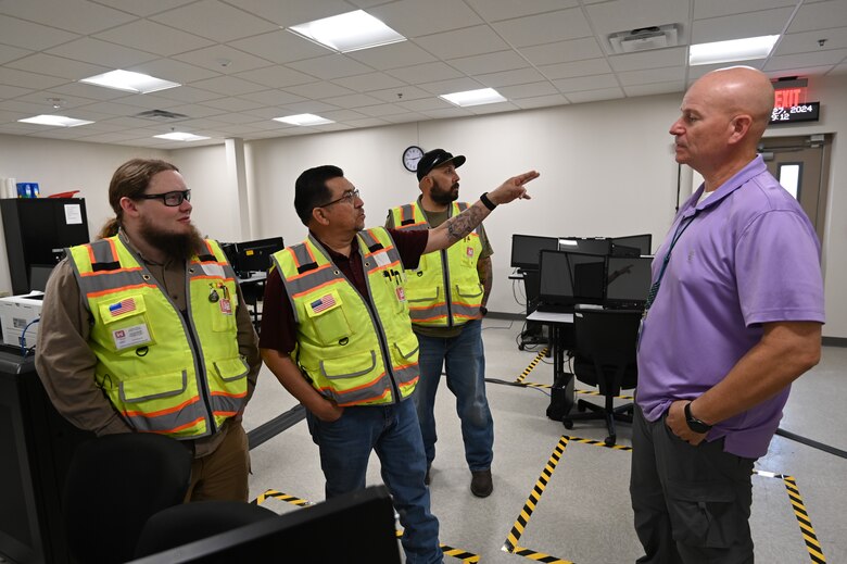 Alex Espinoza, a quality assurance representative from the U.S. Army Corps of Engineers, Fort Worth District’s Southwest Area Office points out work that was done for the building 1093 renovation on Fort Bliss, Texas. Pictured from left to right are Andrew Davis, the project’s engineer from the Southwest Area Office, Alex Espinoza, David Patterson, a construction representative from the Southwest Area Office, and Thomas Harraghy, chief of the Missile Defense Agency’s Kingdom of Saudi Arabia Terminal High Altitude Area Defense Training Academy.