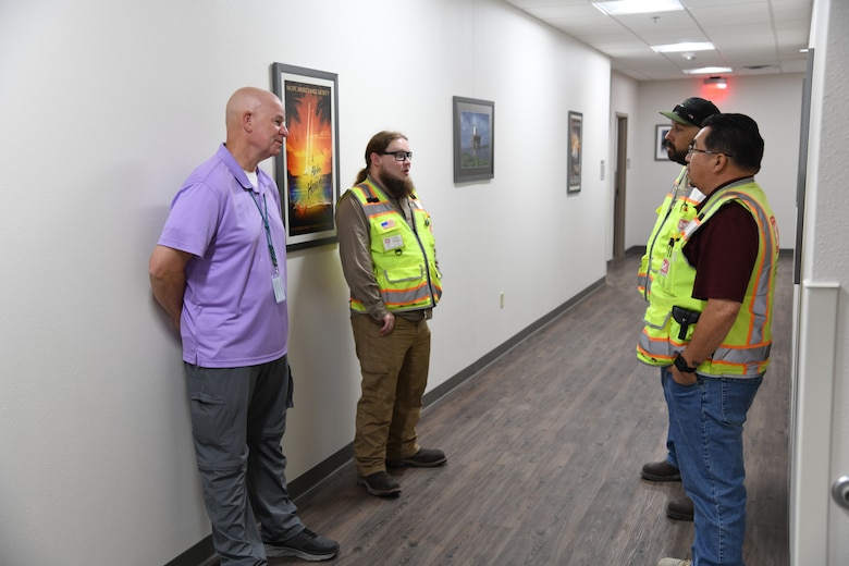 Thomas Harraghy, chief of the Missile Defense Agency’s Kingdom of Saudi Arabia Terminal High Altitude Area Defense Training Academy talks with members of the renovation team of building 1093 on Fort Bliss, Texas. The team completed renovations of the building in just over 18 months. Pictured clockwise are Harraghy (purple shirt), Andrew Davis, the project’s engineer from the Southwest Area Office, David Patterson, a construction representative from the Southwest Area Office, and Alex Espinoza, a quality assurance representative from the U.S. Army Corps of Engineers, Fort Worth District’s Southwest Area Office.