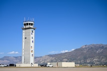 Air traffic tower in front of a mountain background