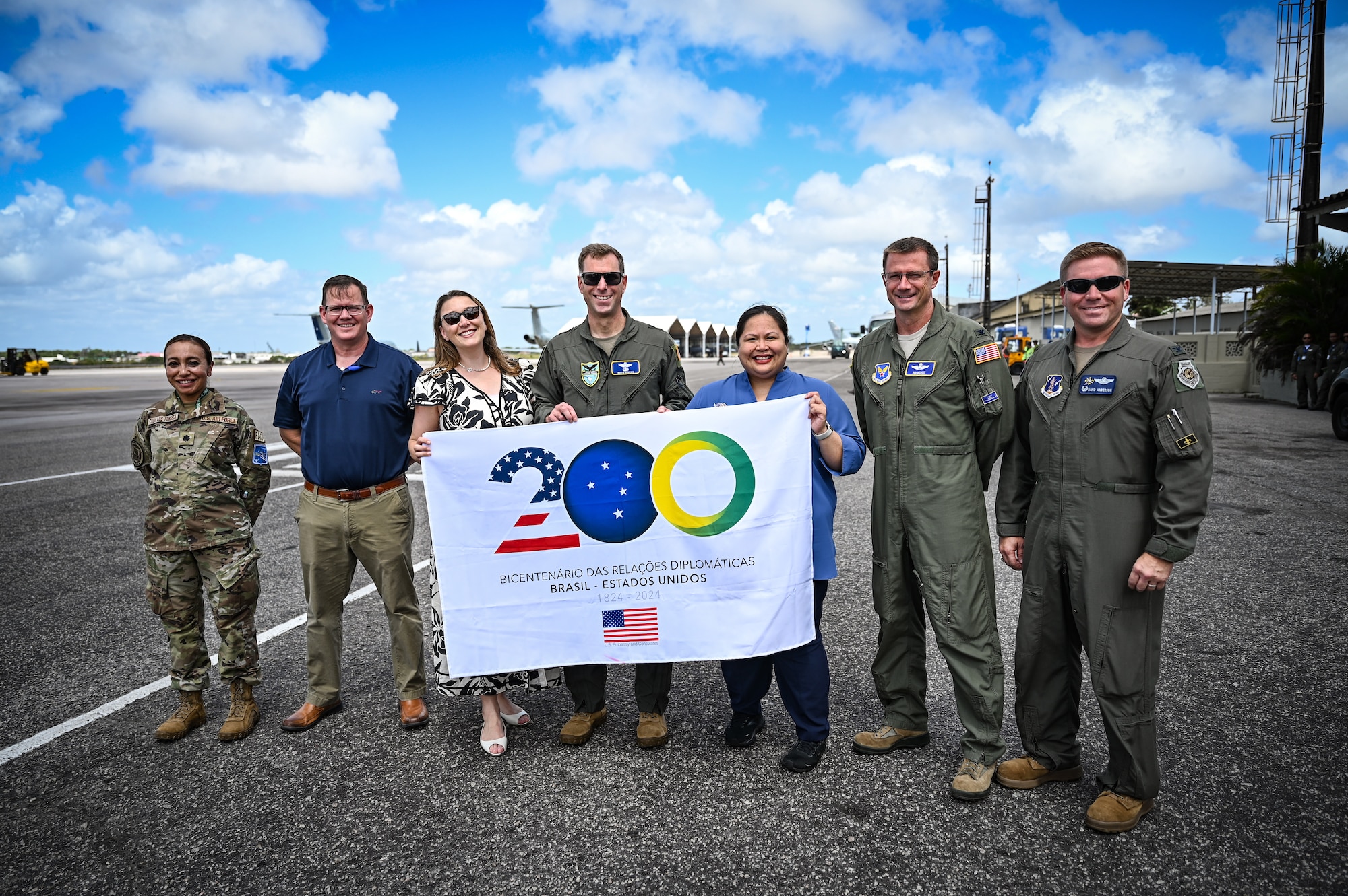United States distinguished visitors and diplomats hold a sign celebrating the bicentennial diplomatic relationship between the U.S. and Brazil during CRUZEX 2024 at Natal Air Force Base, Brazil, Nov. 9, 2024. Since 1824 the U.S. and Brazil have shared values, aspirations, and a commitment to democracy that have shaped the partnership and driven prosperity in the Western Hemisphere. (U.S. Air Force photo by Staff Sgt. Madeline Herzog)