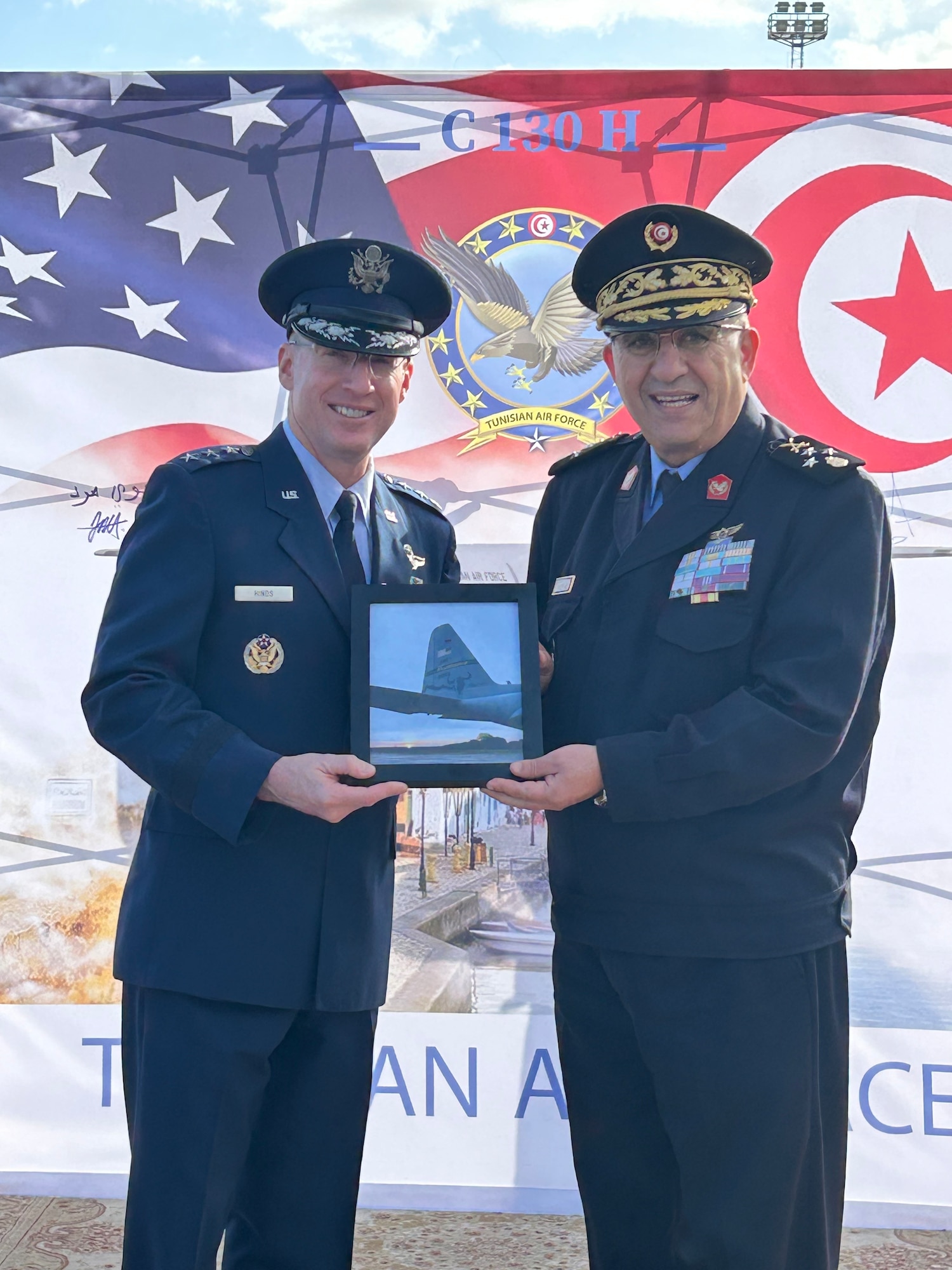 Lt. Gen. Jason T. Hinds (left), Deputy Commander of United States Air Forces in Europe - Air Forces Africa, and Lt. Gen. Mohamed Hajem (right), Chief of Staff of the Tunisian Air Force, commemorate the transfer of a C-130H transport aircraft from the U.S. Air Force to the Tunisian Air Force in Tunis, Tunisia, Nov. 18, 2024. The leaders also took time to discuss regional security concerns and strengthen the nations’ strong bilateral relationship.