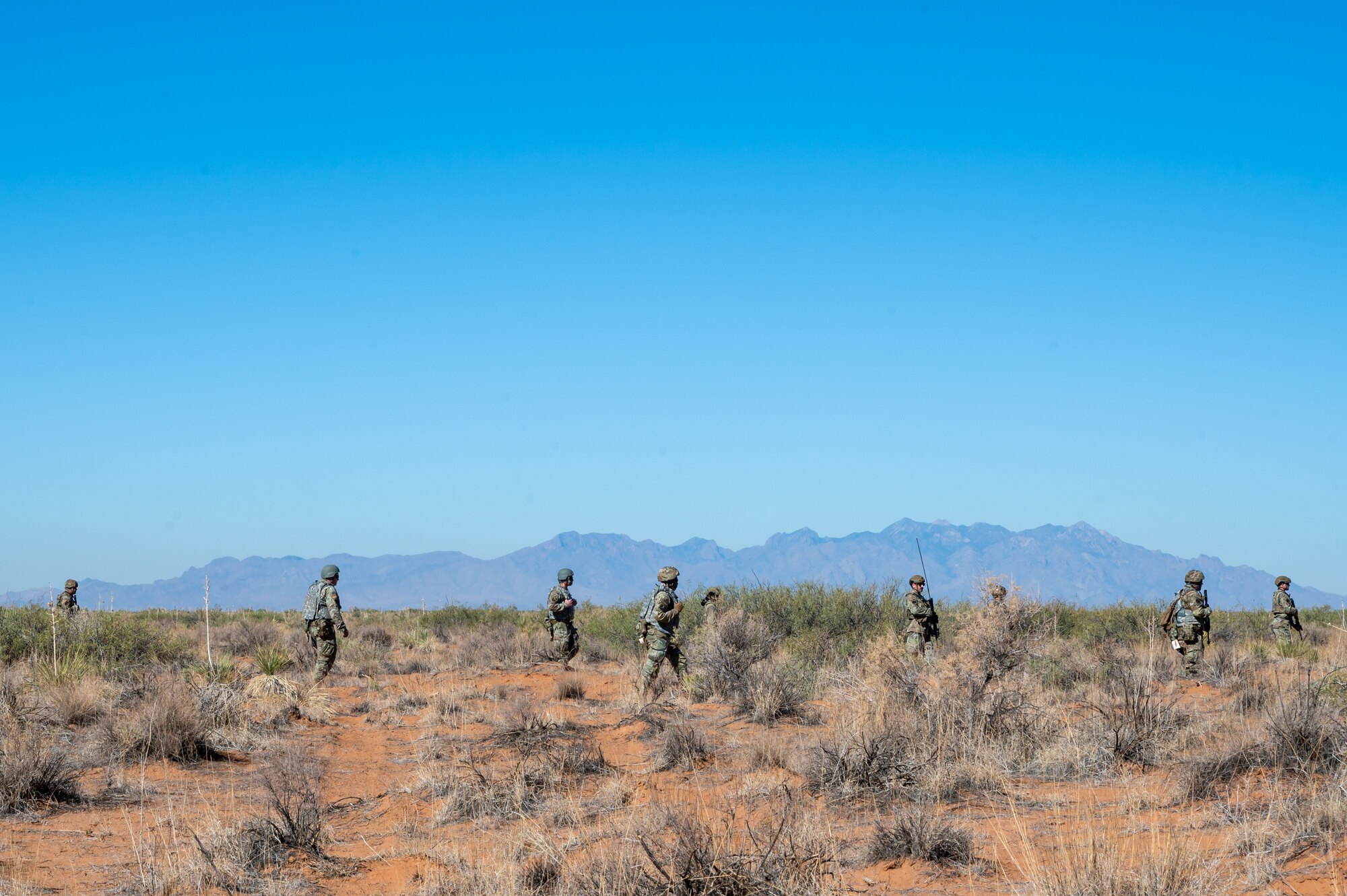 U.S. Airmen assigned to the 11th Air Task Force patrol beyond the base perimeter during the 11th ATF’s first field exercise at McGregor Range, New Mexico, Nov. 9, 2024. Airmen investigated a location where the presence of simulated opposing forces was suspected. (U.S. Air Force photo by Airman 1st Class Jasmyne Bridgers-Matos)