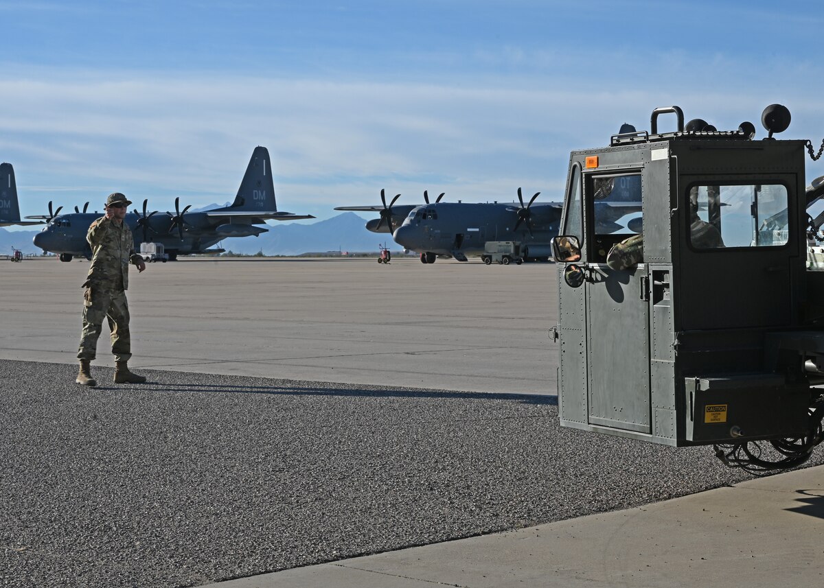 U.S. Air Force Staff Sgt. Harry Edmondson, 355th Logistics Readiness Squadron noncommissioned officer in charge of air transportation function operations, left, directs cargo movement to Airman 1st Class Emanuel Garcia, 355th LRS air terminal function representative, right, at Davis-Monthan Air Force Base, Arizona, Nov. 6, 2024. Edmondson and Garcia utilized agile combat employment to help the Army Test and Evaluation Command with loading 49,500 pounds on a C-17 Globemaster III aircraft. (U.S. Air Force photo by Staff Sgt. Abbey Rieves)