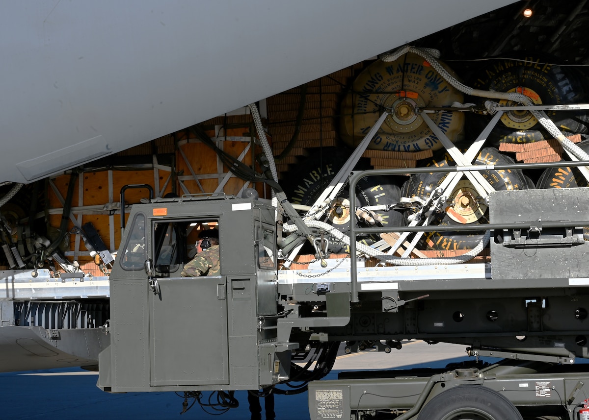 U.S. Air Force Airman 1st Class Emanuel Garcia, 355th Logistics Readiness Squadron air terminal function representative, drives an aircraft loader at Davis-Monthan Air Force Base, Arizona, Nov. 6, 2024. The 355th LRS shared capabilities and resources with the U.S. Army to help develop their austere and heavy load airdrop capabilities in support of a U.S. Transportation Command funded project. (U.S. Air Force photo by Staff Sgt. Abbey Rieves)