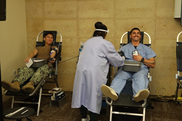 Petty Officer 2nd Class Edreck Manabat, an information systems technician with the Naval Hospital Camp Pendleton Information Management Department, and Seaman Collin Smith, a corpsman in the NHCP Family Medicine Department, donate blood during an Armed Services Blood Program – Camp Pendleton blood drive coordinated by the Navy Medicine Readiness and Training Command Camp Pendleton Junior Enlisted Association on Nov. 18, 2024, in the Naval Hospital Camp Pendleton Galley Meeting Room.