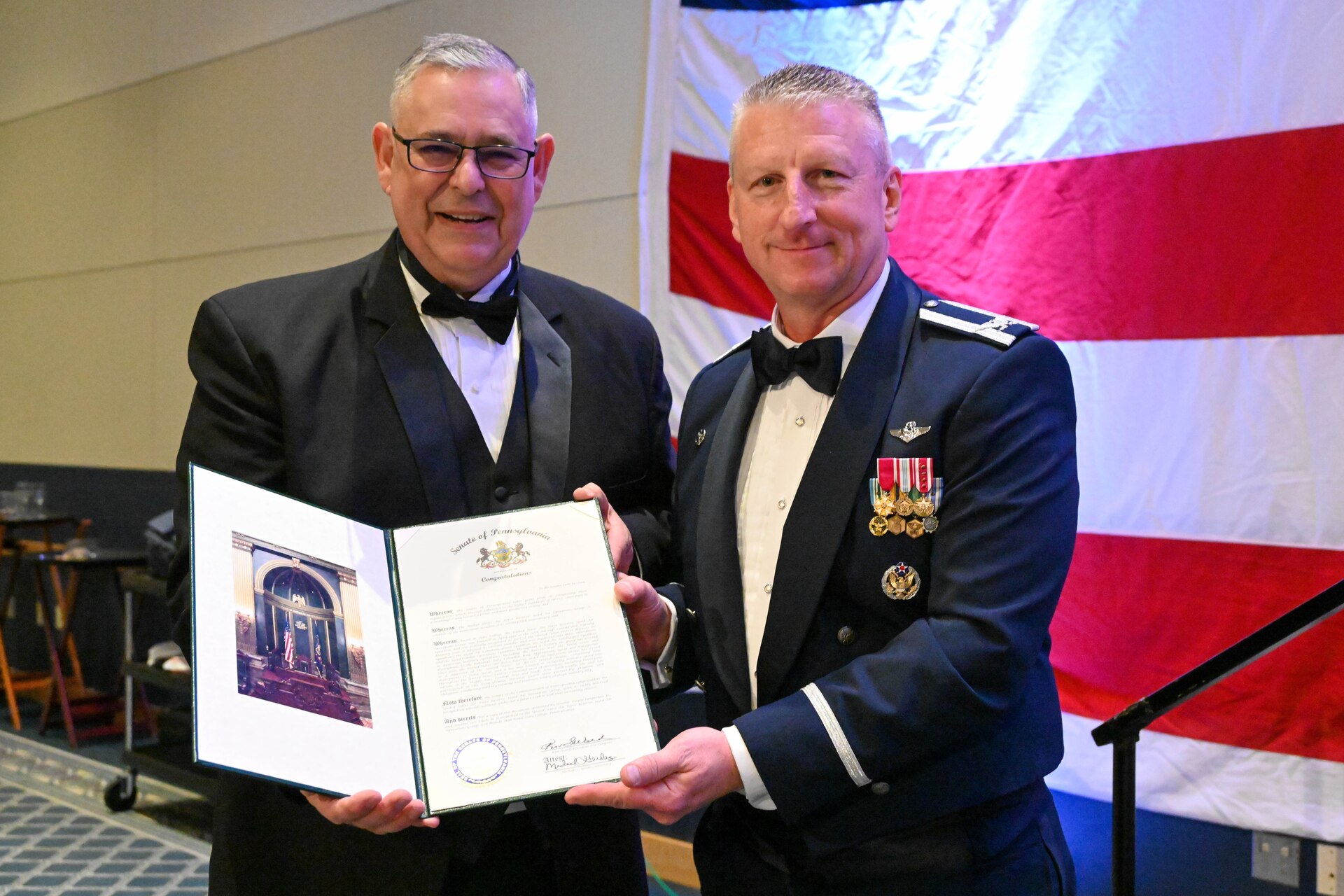 Nearly 250 attendees, including current and former members of the 193rd Air Operations Group, families and distinguished guests, gathered for the unit's 75th anniversary dining out at The Penn Stater Hotel and Conference Center in State College, Pa., Nov. 16, 2024. The event celebrated the unit’s transformation from its origins in a downtown State College garage to its vital role in global and local operations. Highlights of the evening included special presentations, ceremonial toasts and reflections on the group’s storied and enduring legacy. (U.S. Air Force photo by Tech. Sgt. Ted Nichols)