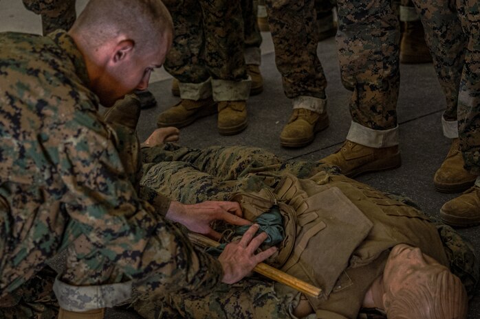 A U.S. Marine Corps recruit with Lima Company, 3rd Recruit Training Battalion, demonstrates the proper technique for applying a tourniquet during a tactical combat casualty care class for recruits with Lima Company, 3rd Recruit Training Battalion, at Marine Corps Recruit Depot San Diego, California, Nov. 5, 2024. TCCC is a three-phase approach to casualty management, ensuring the appropriate medical care is given at the correct time and place during any necessary scenario. (U.S. Marine Corps photo by Lance Cpl. Jacob B. Hutchinson)