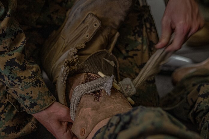 A U.S. Marine Corps recruit with Lima Company, 3rd Recruit Training Battalion, demonstrates the proper technique for an open fracture in a tactical combat casualty care class for recruits with Lima Company, 3rd Recruit Training Battalion, at Marine Corps Recruit Depot San Diego, California, Nov. 5, 2024. TCCC is a three-phase approach to casualty management, ensuring the appropriate medical care is given at the correct time and place during any necessary scenario. (U.S. Marine Corps photo by Lance Cpl. Jacob B. Hutchinson)