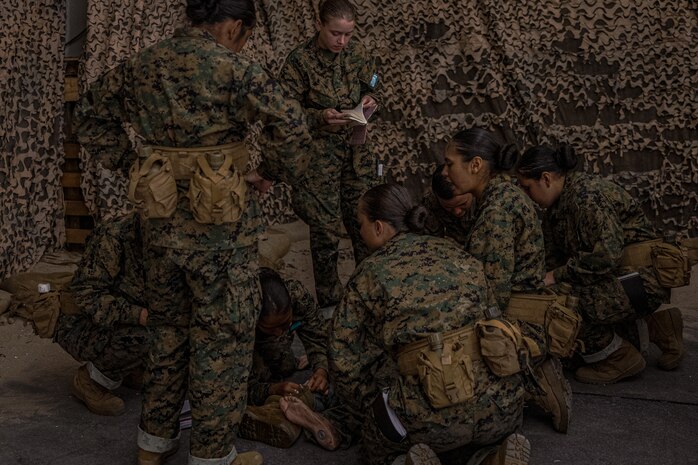 U.S. Marine Corps recruits with Lima Company, 3rd Recruit Training Battalion, practice proper life-saving techniques during in a tactical combat casualty care class for recruits with Lima Company, 3rd Recruit Training Battalion, at Marine Corps Recruit Depot San Diego, California, Nov. 5, 2024. TCCC is a three-phase approach to casualty management, ensuring the appropriate medical care is given at the correct time and place during any necessary scenario. (U.S. Marine Corps photo by Lance Cpl. Jacob B. Hutchinson)