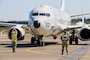 Aviation Machinist Mate 3rd Class Alexander Schrama (left), a Sailor assigned to Patrol Squadron (VP) 46, the ‘Grey Knights,’ directs a P-8A Poseidon to a parking spot while Logistics Specialist Chief Joseph Aceron observes for safety at Naval Air Station Whidbey Island, Washington, Aug. 9, 2024. The aircraft was returning from a flight conducting intelligence, reconnaissance and surveillance. (U.S. Navy photo by Mass Communication Specialist 2nd Class Jacquelin Frost.)