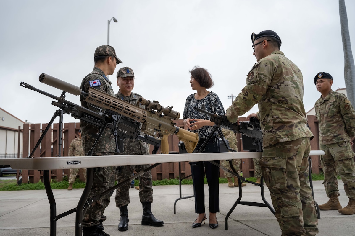 Photo of security forces Airmen showing equipment to visitors