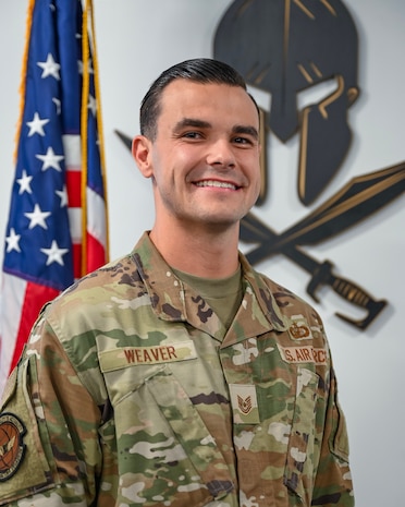 An Airman stands for a photo