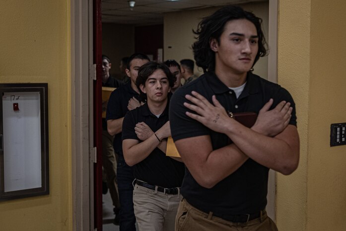 New U.S. Marine Corps recruits with Echo Company, 2nd Recruit Training Battalion, rush inside the contraband room as part of a receiving event at Marine Corps Recruit Depot San Diego, California, Nov. 4, 2024. During the receiving process, recruits are checked for contraband, given a haircut, make a scripted phone calls home, and issued their gear required for training. (U.S. Marine Corps photo by Lance Cpl. Jacob B. Hutchinson)