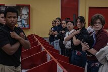 New U.S. Marine Corps recruits with Echo Company, 2nd Recruit Training Battalion, receive their contraband brief as part of a receiving event at Marine Corps Recruit Depot San Diego, California, Nov. 4, 2024. During the receiving process, recruits are checked for contraband, given a haircut, make a scripted phone calls home, and issued their gear required for training. (U.S. Marine Corps photo by Lance Cpl. Jacob B. Hutchinson)