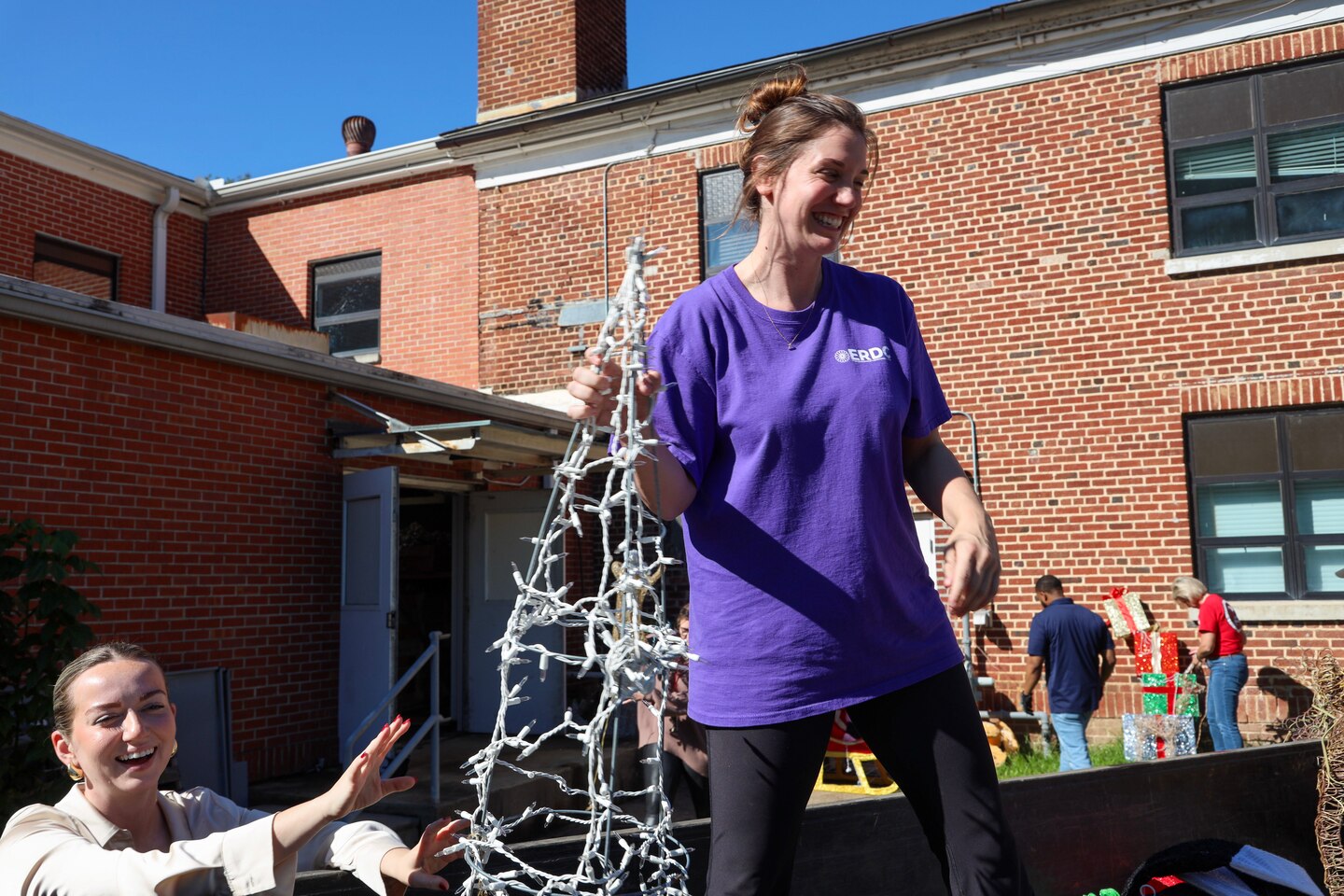 Team members from the U.S. Army Engineer Research and Development Center (ERDC) load a trailer with holiday decorations, gearing up to spread festive cheer at the annual ERDC Under Lights event, set for Dec. 5-6.