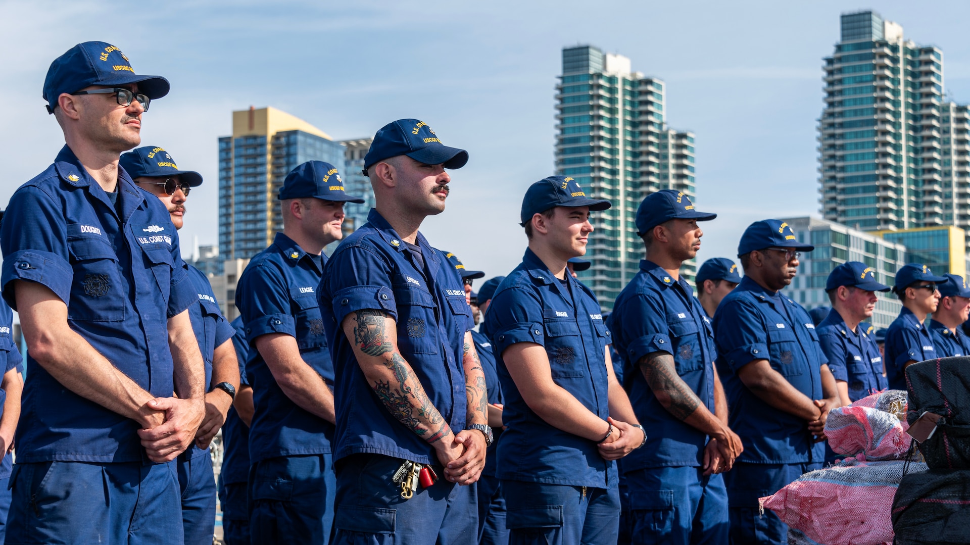 Crewmembers of the U.S. Coast Guard Cutter Munro (WMSL 755) stand on the flight deck of the cutter during the contraband offload in San Diego, Nov. 19, 2024.  The Munro's crew interdicted the narcotics in the Eastern Pacific during counter-narcotic patrols, seizing 29,000 pounds of cocaine worth an estimated wholesale value of $335.8 Million. (U.S. Coast Guard photo by Petty Officer 3rd Class Richard Uranga)