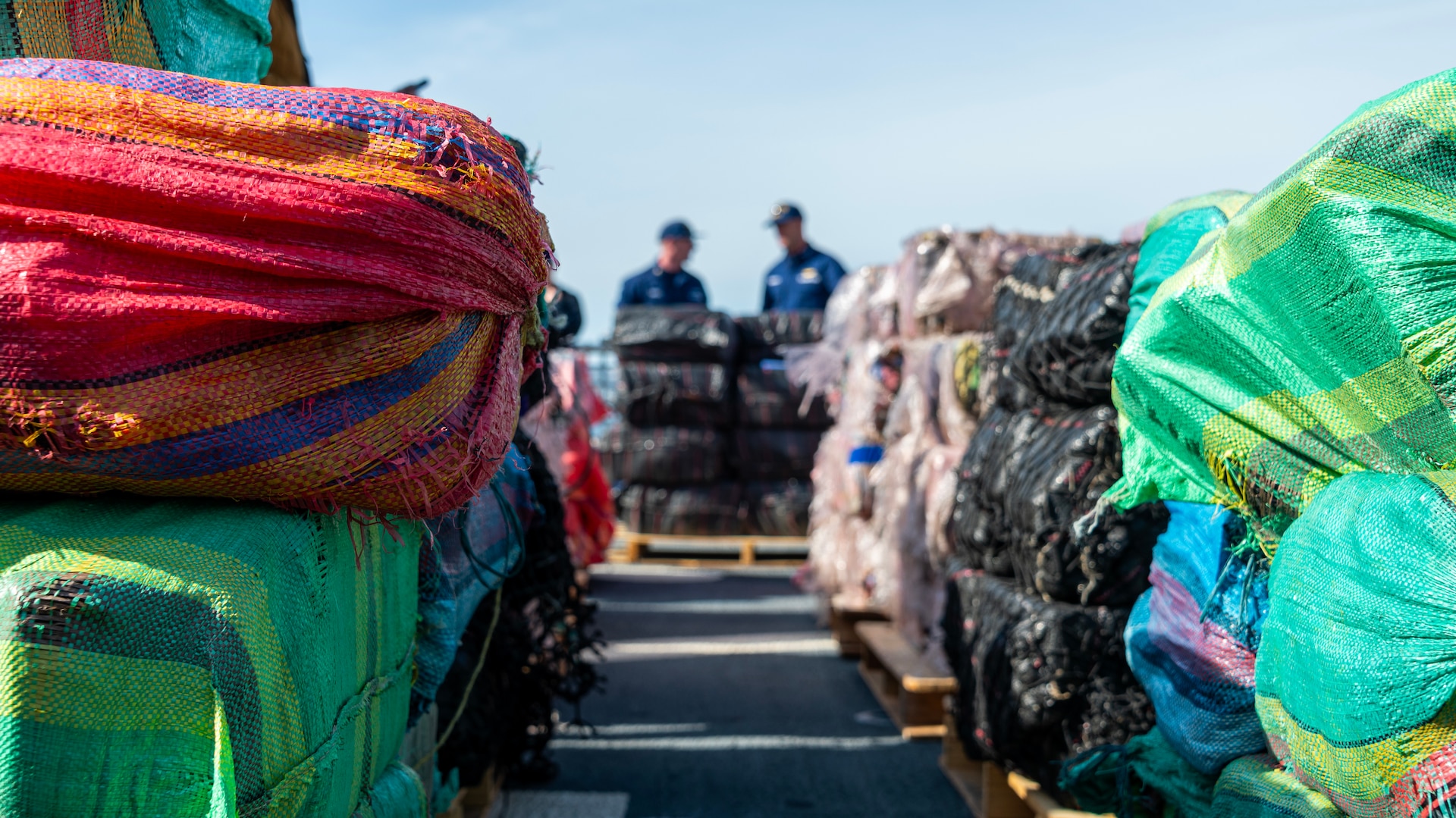 Crewmembers of the U.S. Coast Guard Cutter Munro (WMSL 755) stand on the flight deck of the cutter during the contraband offload in San Diego, Nov. 19, 2023.  The Munro's crew interdicted the narcotics in the Eastern Pacific during counter-narcotic patrols, seizing 29,000 pounds of cocaine worth an estimated wholesale value of $335.8 Million. (U.S. Coast Guard photo by Petty Officer 3rd Class Richard Uranga)