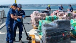 Crewmembers of the U.S. Coast Guard Cutter Munro (WMSL 755) work on the flight deck of the cutter during the contraband offload in San Diego, Nov. 19, 2024.   The Munro crew members interdicted the narcotics in the Eastern Pacific during counter-narcotic patrols, seizing 29,000 pounds of cocaine worth an estimated wholesale value of $335.8 million.  (U.S. Coast Guard photo by Petty Officer 3rd Class Richard Uranga)