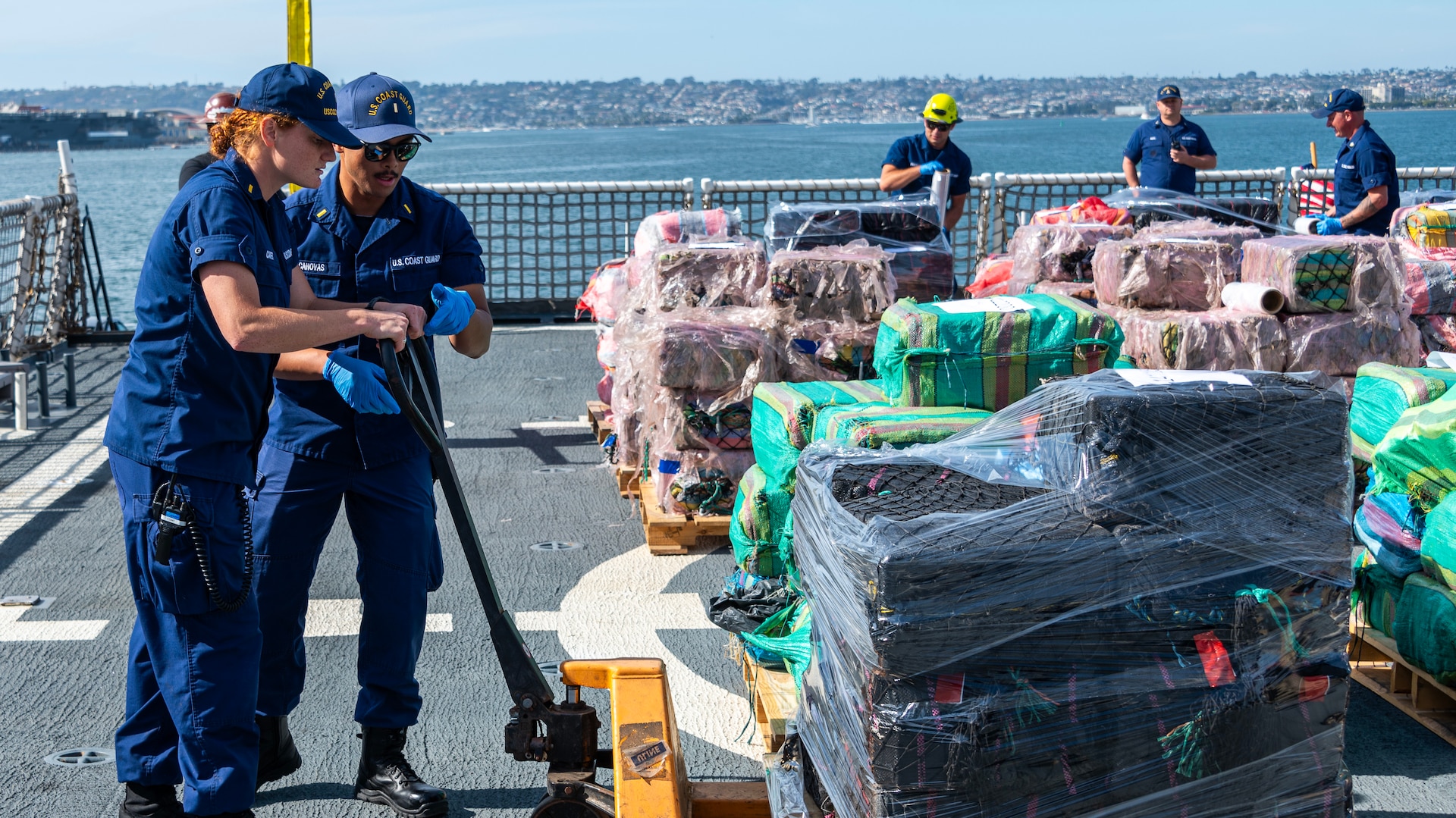 Crewmembers of the U.S. Coast Guard Cutter Munro (WMSL 755) work on the flight deck of the cutter during the contraband offload in San Diego, Nov. 19, 2024.   The Munro crew members interdicted the narcotics in the Eastern Pacific during counter-narcotic patrols, seizing 29,000 pounds of cocaine worth an estimated wholesale value of $335.8 million.  (U.S. Coast Guard photo by Petty Officer 3rd Class Richard Uranga)