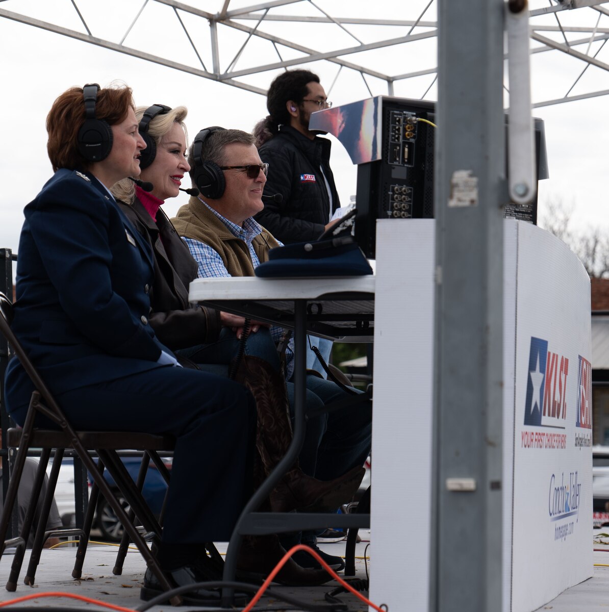 U.S. Air Force Col. Angelina Maguinness, 17th Training Wing commander, announces floats in the Veterans Day Parade along with Carolyn McEnrue and Randy Turner, anchors from local news station KLST in San Angelo, Texas, Nov. 9, 2024. The Veterans Day parade featured local businesses, charities, veterans groups, and military formations filled by volunteers from Goodfellow Air Force Base. (U.S. Air Force photo by Staff Sgt. Nathan Call)