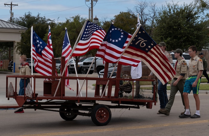 Boy Scouts from San Angelo Troop 363 present historical flags during the Veterans Day Parade in downtown San Angelo, Texas, Nov. 9, 2024. The parade featured military members from Goodfellow Air Force Base, local organizations and schools. (U.S. Air Force photo by Staff Sgt. Nathan Call)