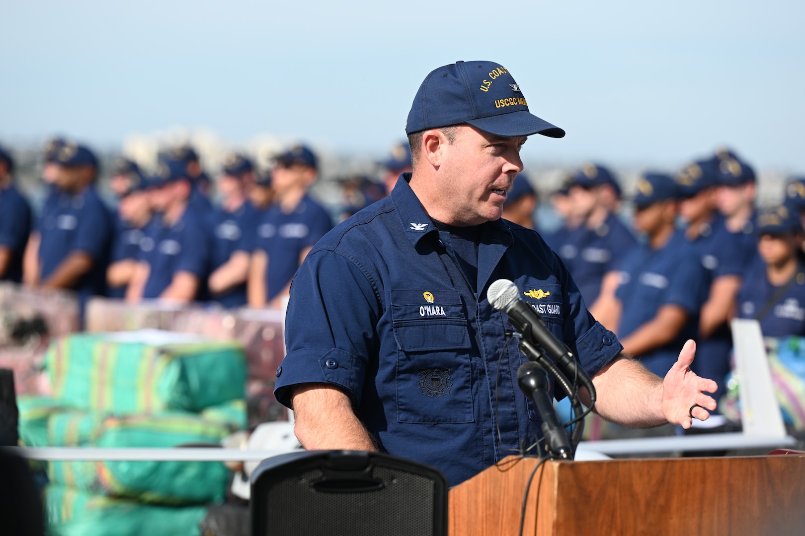 Capt. James O’Mara, commanding officer of the U.S. Coast Guard Cutter Munro (WMSL 755), speaks to media aboard the Munro’s flight deck while moored in San Diego to offload contraband seized during a counterdrug patrol, Nov. 19, 2024. The offload is a result of eleven separate suspected drug smuggling vessel interdictions or events off the coasts of Mexico and Central and South America by the Coast Guard Cutters Munro, Vigorous, Hamilton, and the USS St. Louis in September and October. U.S. Coast Guard photo by Petty Officer 3rd Class Austin Wiley.