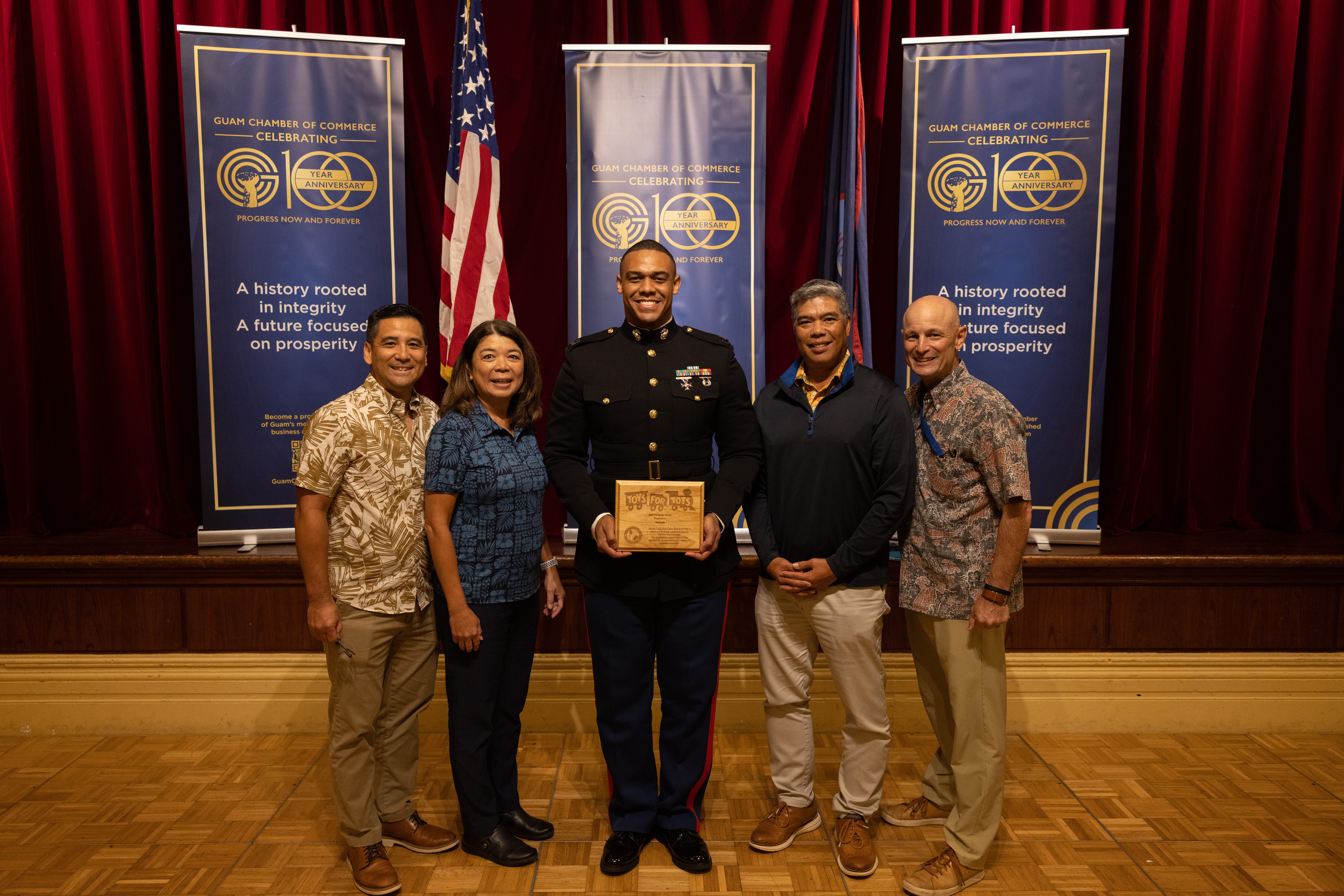 U.S. Marine Corps Capt. Ryan West, Headquarters Company Commander, Marine Corps Base Camp Blaz, poses with members of the Guam Chamber of Commerce during the Toys for Tots kick-off in Tumon, Guam, Sept. 25, 2024. This year marks the 15th year Toys for Tots has been part of the Guam community. “Our island community has been extremely generous in its support of the Toys for Tots campaign over the years," said Catherine Castro, President of the Guam Chamber of Commerce. "Even when times were lean, our residents have been the most supportive, which has been amazing to witness!” (Marine Corps photo by Cpl. Ryan Little)