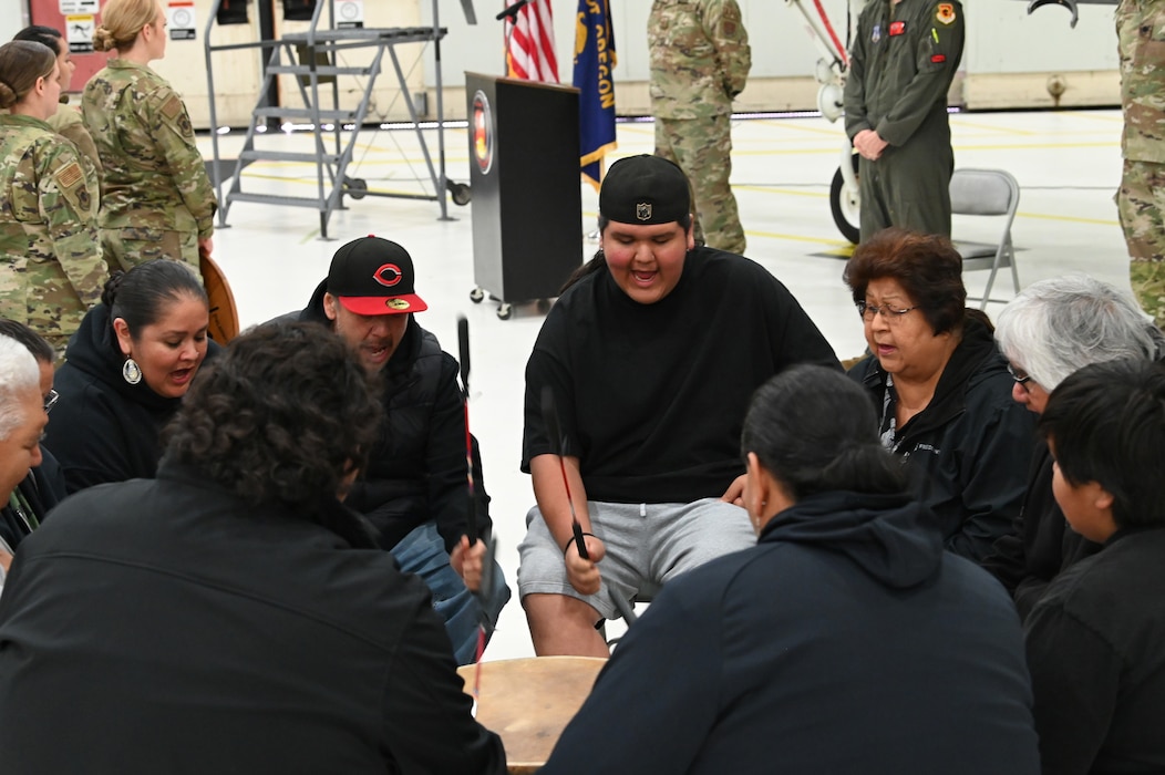 People play a drum in a circle.