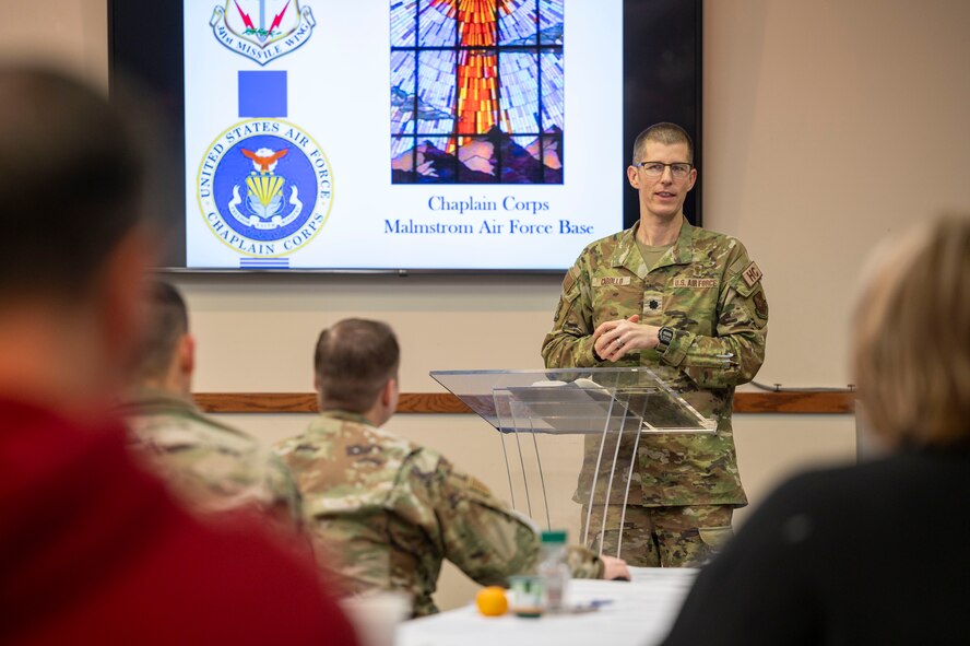 A man standing at a podium speaking to a group of people.