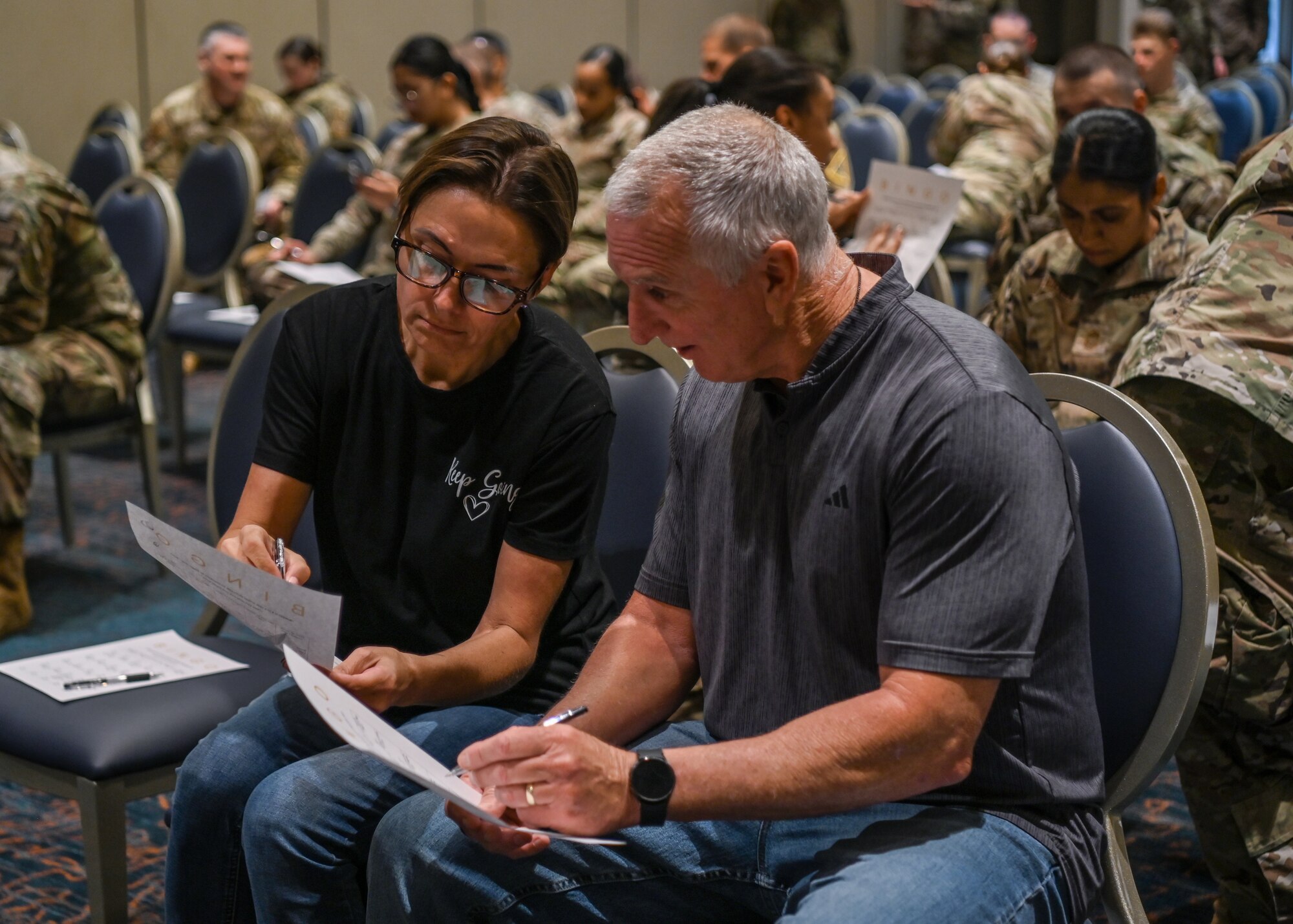 The Hawks Cove integrated prevention and response director and a Hawks Cove prevention coordination specialist, play a game of bingo during a wingman event at Vandenberg Space Force Base.