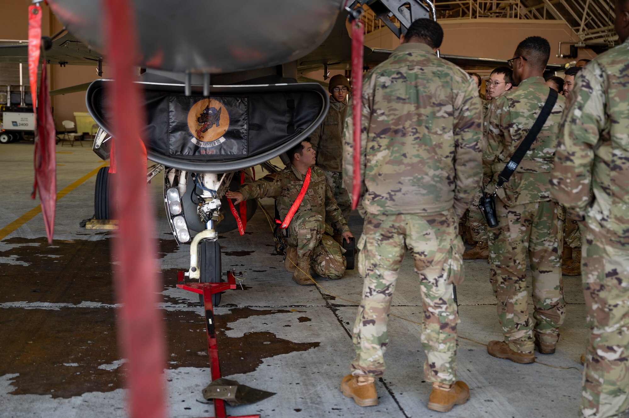 U.S. Air Force members assigned to the 51st Fighter Wing discuss safety procedures during Radiant Falcon at Osan Air Base, Republic of Korea, Nov. 13, 2024. Radiant Falcon is a cross functional training event that brought together multiple career fields to maintain a simulated nuclear contaminated aircraft. These exercises ensure that the 51st FW can “Fight Tonight,” no matter the scenario. (U.S. Air Force photo by Senior Airman Brittany Russell)
