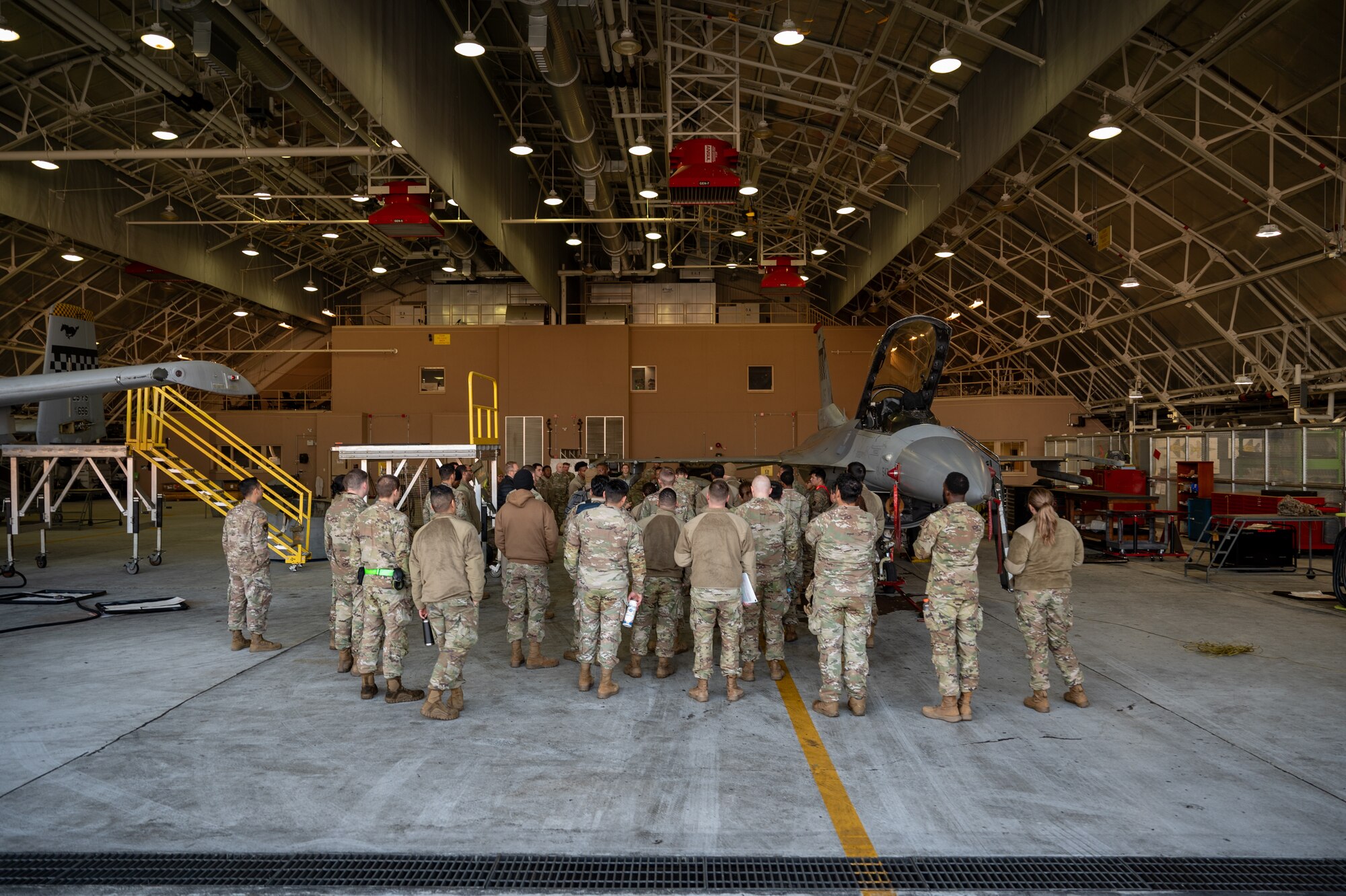U.S. Air Force members assigned to the 51st Fighter Wing discuss safety procedures during Radiant Falcon at Osan Air Base, Republic of Korea, Nov 13, 2024. Radiant Falcon is a cross functional training event where members work on a simulated nuclear contaminated aircraft. This training ensures that no matter the conditions, the 51st FW will maintain airpower and defend the freedom of 51 million people on the Korean peninsula. (U.S. Air Force photo by Senior Airman Brittany Russell)